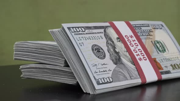 Dollars Bundles Rotate on Green Background Heap of Money alt