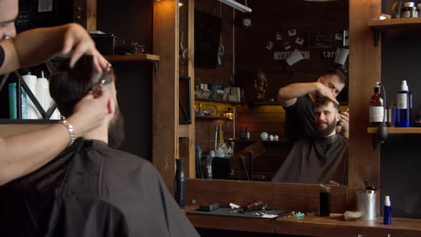 Barber Cutting Hair of Male Client