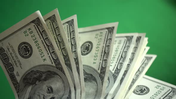 Lot Of 100 Dollar Bills Isolated On Chroma Key Green Screen Background alt