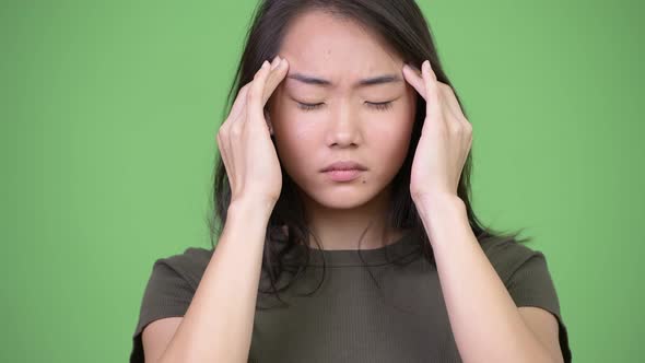 Young Stressed Asian Woman Having Headache