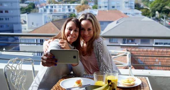 Lesbian Couple Taking Selfie in Balcony 4k alt