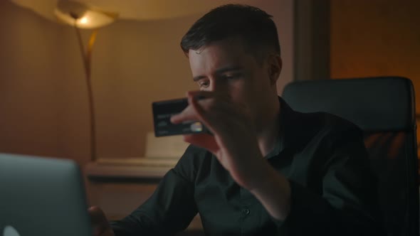 Young Businessman Making Online Purchase with Plastic Card in Online Shop alt