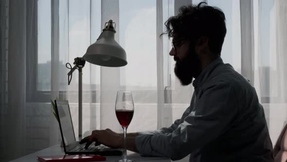 Bearded Man That Works at the Computer Full of Reminder Notes Drink Wine alt