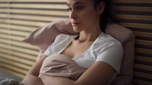 Tracking video of depressed woman in bed. Shot with RED helium camera in 8K. alt