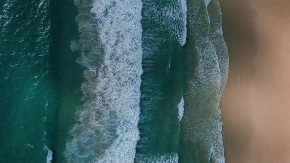 Sea waves and beautiful white sand beach aerial view drone shot footage top view for the beach.