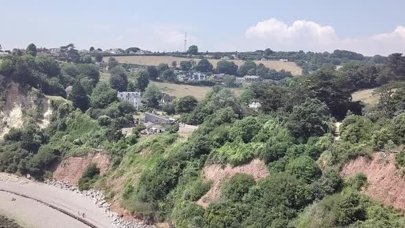 Flying close to the cliffs and rock formations on the beach of Seaton in east Devon, England. The wh alt