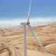 Aerial Close Up Footage of a Spinning Windmill at a Windfarm Over the Fields - VideoHive Item for Sale
