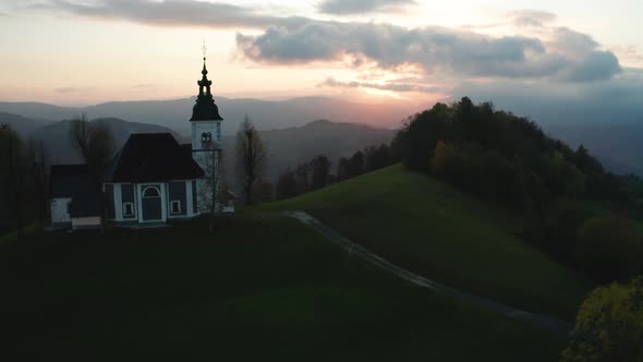 Amazing Beautiful Aerial View of the Hills, Colorful Forest and the Sv Sobota Church, Slovenia