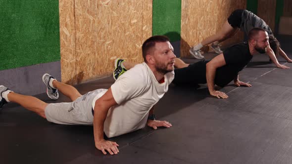 Happy Men Doing Fitness Exercises Bending Forward and Stretching alt
