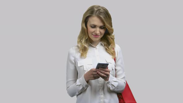 Portrait of a Young Attractive Blong Woman Messaging with Someone Online alt