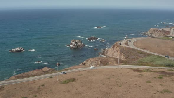 Aerial view of cars driving down Highway 1 by the ocean Bodega Bay n Northern California alt