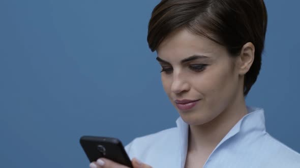 Pretty woman connecting with her smartphone