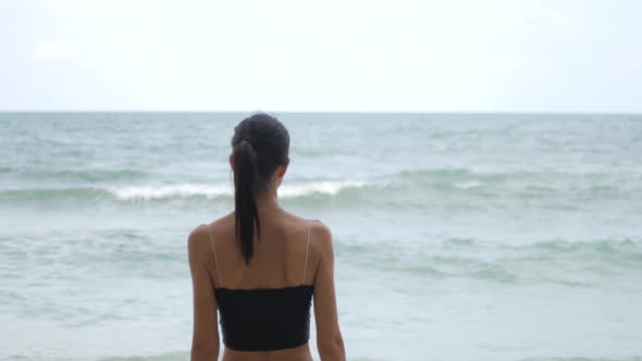 Young Woman Looking at the Sea Into the Distance