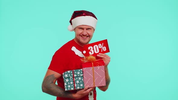 Man in Christmas Tshirt Showing Gift Boxes and 30 Percent Discount Inscriptions Banner Text Note alt