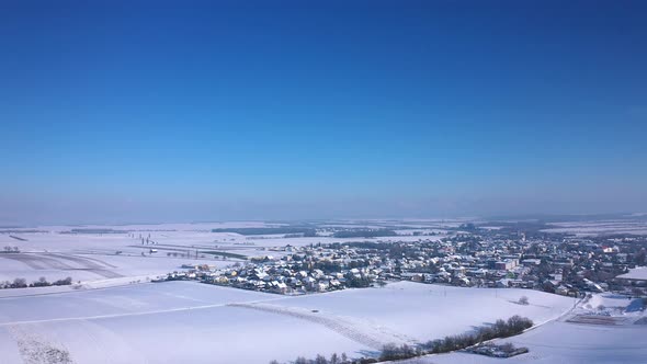 Idyllic Town Of Zistersdorf On Winterly Landscape Against Blue Sky In Lower Austria. Aerial Wide Sho alt