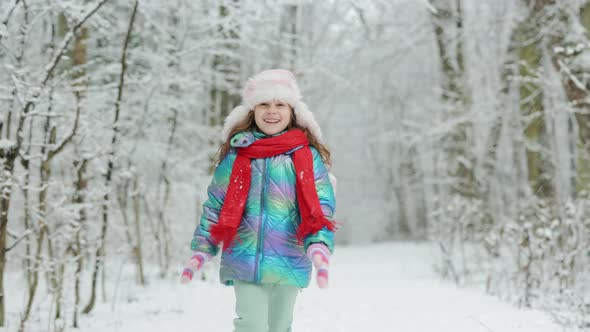 Funny Laughing Child Girl Running in a Beautiful Snowy Park
