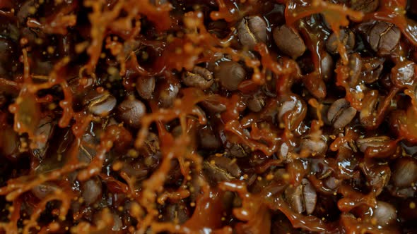 Super Slow Motion Shot of Falling and Splashing Coffee Beans Into Caffee at 1000 Fps. alt