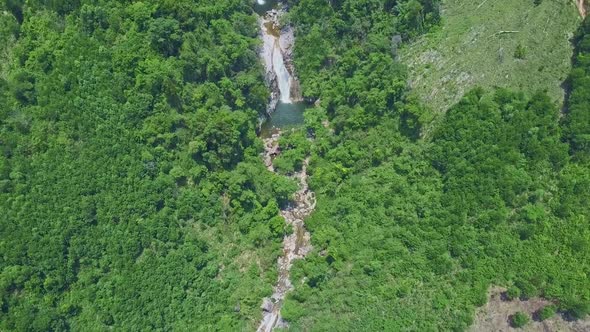 Drone Flies Along Narrow River in Green Canyon of Highland alt