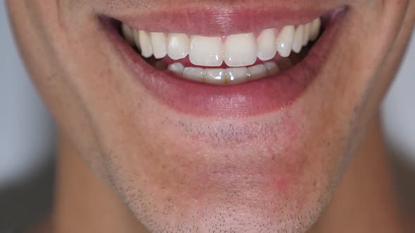 Closeup shot of young man smiling. alt