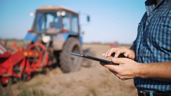Farmer is Using Digital Tablet alt