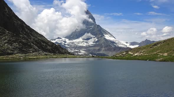 Time lapse of snowy Matterhorn peak and lake Stellisee, Swiss Alps