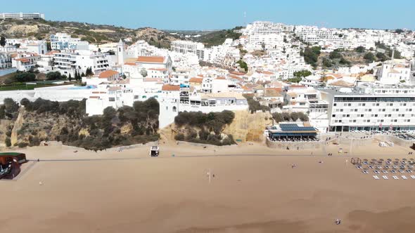 Panoramic of Albufeira mediterranean shoreline in Algarve, Portugal - Pan Aerial shot alt
