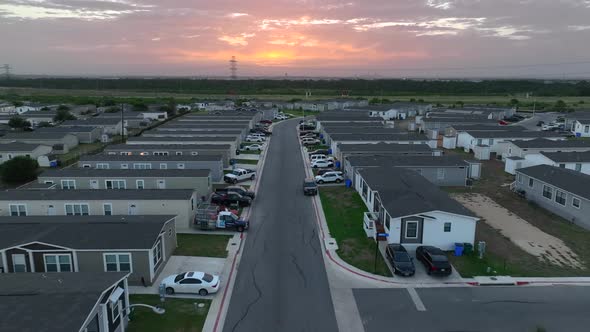 Pick up trucks and cars parked at mobile home trailer park in rural USA in deep south. alt
