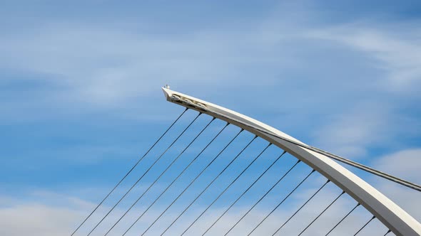 Time lapse of Samuel Beckett Bridge in Dublin City on sunny day with clouds in the sky in Ireland. alt
