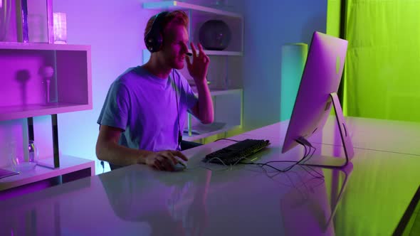 Excited Gamer Talking Team on Online Stream in Home Neon Cyberspace Studio alt