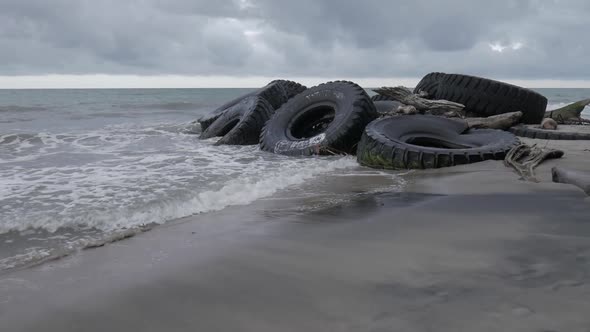 Giant tires on the beach orbit shot alt
