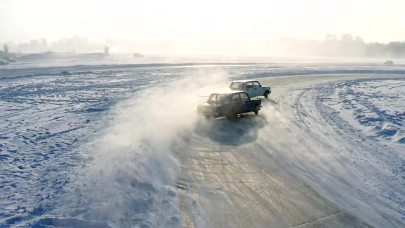 Slow Motion of Two Racing Cars Drifting on an Ice Track