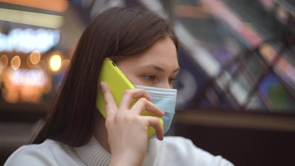 Woman in Protective Mask Talking on the Phone Smiling at Airport Public Center