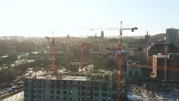 Aerial View of a Construction Site with Cranes and Heavy Machinery alt