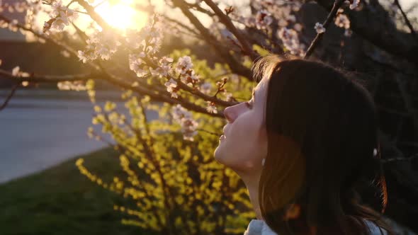 Girl Takes off a Medical Mask and Breathes Deeply of the Spring Blossom after Coronavirus Quarantine