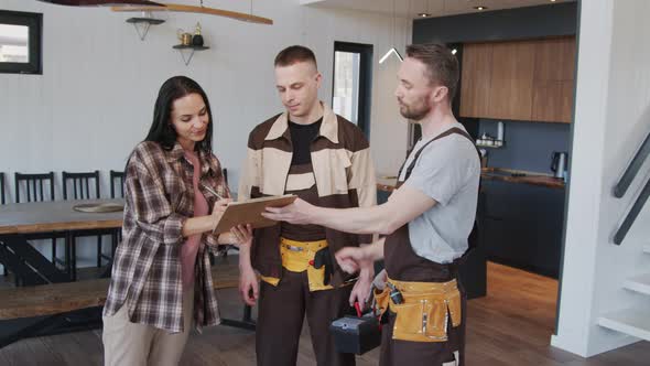 Woman and Handymen Posing in House alt