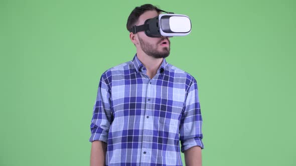 Young Bearded Hipster Man Using Virtual Reality Headset alt