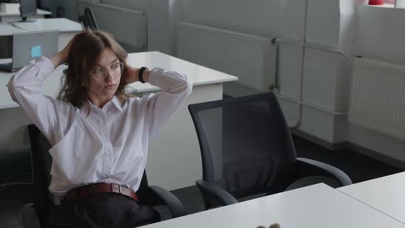 Girl Touches Her Short Wavy Hair and Look at the Window alt