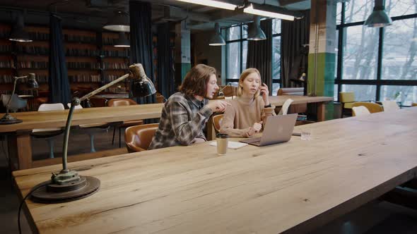 Man and Woman Freelancers Working Together at Coworking Space Discussing New Startup Project on alt