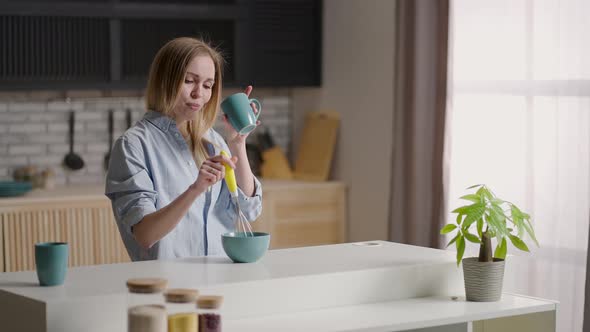 Attractive Girl Dancing in the Kitchen in the Early Morning alt