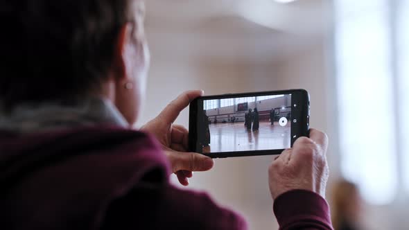 Kendo Tournament  People Fight in the Gym and a Man Recording the Fight on the Phone alt