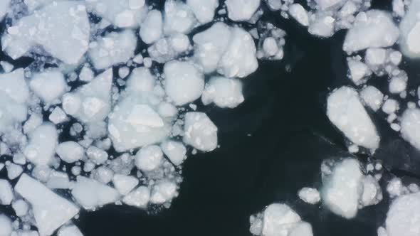 Drone View Vertically Down to Frozen Ice Floes Mixed with Icefree Water alt