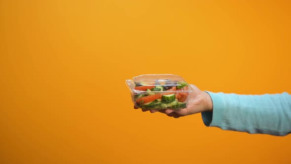 Lady Taking Fresh Vegetable Salad in Plastic Package, Buying Takeaway Food alt