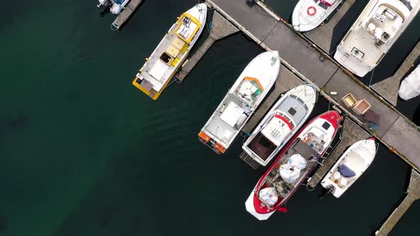 Overhead View Of Fishing Boats And Yachts Moored At Marina. - aerial alt