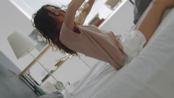 Sleepy Woman Falling on Bed alt