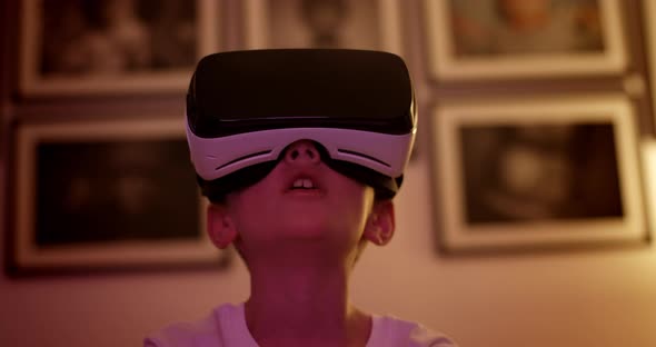 Boy Wearing Virtual Reality Headset Looking Round