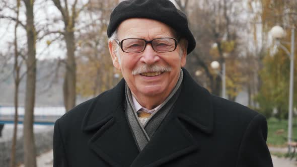close up portrait of handsome american elderly man looking to camera intense focused alt