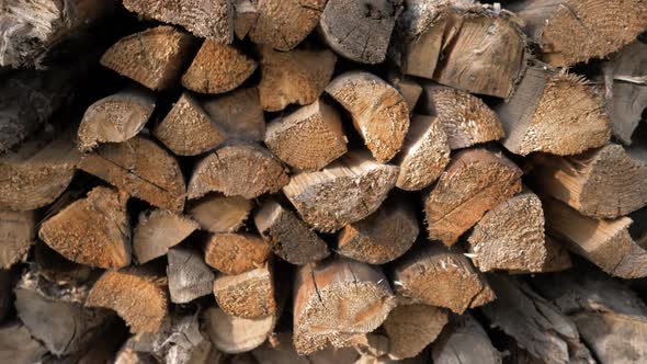 Logs of Firewood Neatly Layered in the Woodpile alt
