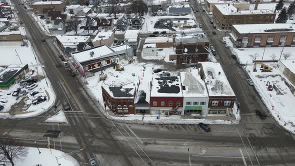 View over small urban town in winter with large intersection and older buildings.