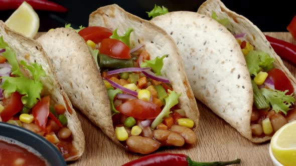 The Mexican Dish of Tako Corn Flat Cake with Vegetable Filling on a Wooden Board alt