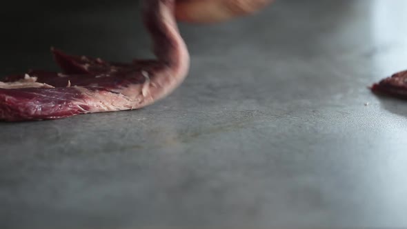 Chef cutting beef fillets for barbecue